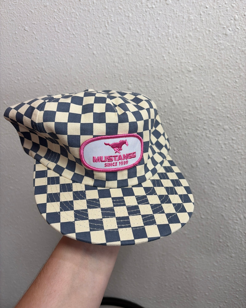 blue checkered cap with pink patch